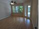 Bedroom with a ceiling fan and lanai access at 19116 Nature Palm Ln, Tampa, FL 33647