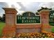 Entrance sign for Hawthorne Estates with brick facade and flower beds at 19116 Nature Palm Ln, Tampa, FL 33647