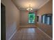 Formal dining room featuring neutral paint, tile floors, decorative chandelier, and a large window for natural light at 19116 Nature Palm Ln, Tampa, FL 33647