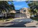Charming two-story home featuring a three-car garage, landscaped front yard, and a well-maintained driveway at 19116 Nature Palm Ln, Tampa, FL 33647