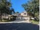 Beautiful two-story home with a three-car garage, lush landscaping, and a spacious driveway for multiple vehicles at 19116 Nature Palm Ln, Tampa, FL 33647