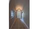 Foyer featuring a white door, tile flooring, arched ceiling, and decorative light fixture that enhance the welcome at 19116 Nature Palm Ln, Tampa, FL 33647