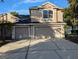 Two-story home featuring a three-car garage, neutral stucco exterior and a well-maintained driveway with mature landscaping at 19116 Nature Palm Ln, Tampa, FL 33647