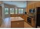 Kitchen has ample counter space, wood cabinets and stainless steel appliances at 19116 Nature Palm Ln, Tampa, FL 33647