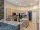 Kitchen features stone accent wall and island with breakfast bar at 19116 Nature Palm Ln, Tampa, FL 33647