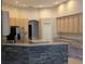 Kitchen features light wood cabinetry and an island at 19116 Nature Palm Ln, Tampa, FL 33647
