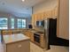 Bright kitchen with stainless steel appliances, center island, and views to the exterior at 19116 Nature Palm Ln, Tampa, FL 33647