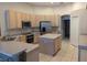Kitchen showcases light wood cabinets, stainless appliances, an island, and eat in dining area at 19116 Nature Palm Ln, Tampa, FL 33647