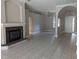 Open-concept living area features tile flooring, arched doorways, and a stone fireplace at 19116 Nature Palm Ln, Tampa, FL 33647