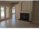 Living room features a stone fireplace and tile floors, with a view to the outside patio through glass doors at 19116 Nature Palm Ln, Tampa, FL 33647
