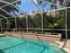 Beautiful screened-in pool with lush landscaping, creating a private and serene outdoor oasis at 19116 Nature Palm Ln, Tampa, FL 33647