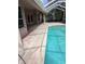 Inviting screened-in pool area featuring a refreshing blue pool and tiled patio for relaxing and entertaining at 19116 Nature Palm Ln, Tampa, FL 33647