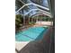 Stunning screened-in pool area offering a peaceful retreat with mature landscaping and a covered enclosure at 19116 Nature Palm Ln, Tampa, FL 33647