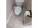 Close up of a toilet with a bidet attachment in a tiled bathroom at 19116 Nature Palm Ln, Tampa, FL 33647