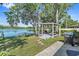 Beautiful backyard with a gazebo-covered seating area, grill, and picturesque lake access at 19254 Blount Rd, Lutz, FL 33558