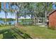 Serene backyard with a gazebo, lake view, and lush greenery at 19254 Blount Rd, Lutz, FL 33558