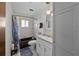 Bathroom with bathtub, sink, hanging lights and decorative mirror at 19254 Blount Rd, Lutz, FL 33558