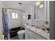 Bathroom with bathtub, sink, hanging lights and decorative mirror at 19254 Blount Rd, Lutz, FL 33558