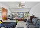 Spacious bedroom with lake view featuring a ceiling fan, tile flooring, and large windows at 19254 Blount Rd, Lutz, FL 33558