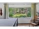 Bedroom with large window, wood rocking chair, and decorative ceiling fan at 19254 Blount Rd, Lutz, FL 33558