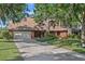 Charming brick home with a well-manicured lawn and mature trees at 19254 Blount Rd, Lutz, FL 33558