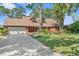 Charming brick home with a two-car garage and a beautifully landscaped front yard at 19254 Blount Rd, Lutz, FL 33558
