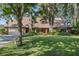 Traditional brick home featuring a lush lawn, mature trees, and a spacious driveway at 19254 Blount Rd, Lutz, FL 33558