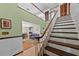 Bright foyer featuring a staircase and view into a living room with wood floors at 19254 Blount Rd, Lutz, FL 33558