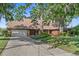 Charming brick home featuring a well-manicured lawn, mature trees, and a spacious driveway at 19254 Blount Rd, Lutz, FL 33558