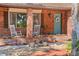 Charming brick home featuring a welcoming front porch with rocking chairs and beautiful landscaping at 19254 Blount Rd, Lutz, FL 33558