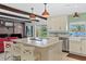 Modern kitchen featuring stainless steel appliances, an island, and views of the backyard at 19254 Blount Rd, Lutz, FL 33558