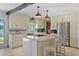 Modern kitchen featuring stainless steel appliances, an island, and a bright, open layout at 19254 Blount Rd, Lutz, FL 33558