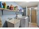 Laundry room with a large sink, updated washing machine, and a standing shower at 19254 Blount Rd, Lutz, FL 33558