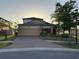 Charming one-story home features a well-manicured lawn, brick driveway and a two-car garage at 19514 Sea Myrtle Way, Tampa, FL 33647