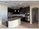 Modern kitchen featuring dark cabinetry, stainless steel appliances, and a granite-topped island at 19514 Sea Myrtle Way, Tampa, FL 33647