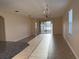 Sunlit living room boasting tile floors, a ceiling fan, and sliding glass doors to the backyard at 19514 Sea Myrtle Way, Tampa, FL 33647