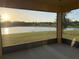 Enjoy serene views of the pond and backyard landscape from the covered screened-in patio at 19514 Sea Myrtle Way, Tampa, FL 33647