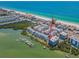 Aerial shot showcasing coastal property with beach access, featuring dock and stunning waterfront views at 19925 Gulf Blvd # 503, Indian Shores, FL 33785