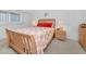 Bedroom with hardwood furnishings and a comfortable queen-sized bed with coral accents at 19925 Gulf Blvd # 503, Indian Shores, FL 33785