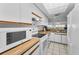 Bright kitchen offers tile floor, wood countertops and skylight at 19925 Gulf Blvd # 503, Indian Shores, FL 33785