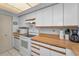 Bright kitchen with white appliances and wood countertop at 19925 Gulf Blvd # 503, Indian Shores, FL 33785