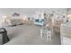 Well-lit living room and dining area with water views and updated finishes throughout the home at 19925 Gulf Blvd # 503, Indian Shores, FL 33785