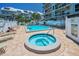 Community spa and pool area with apartment buildings and lounge chairs at 19925 Gulf Blvd # 503, Indian Shores, FL 33785