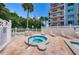 Community spa area with a seating area near the apartment building at 19925 Gulf Blvd # 503, Indian Shores, FL 33785