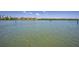 Picturesque waterfront view with a boat on the water, showcasing a serene and scenic location at 19925 Gulf Blvd # 503, Indian Shores, FL 33785