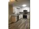 Modern kitchen with white cabinets, stainless steel appliances, granite countertops, and stylish flooring at 211 Harmony Ln, Brandon, FL 33511