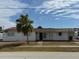 Front exterior view featuring the lawn, carport, driveway, and front entrance at 21811 Edgewater Dr, Port Charlotte, FL 33952