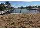 Picturesque waterfront view showcases a tranquil waterway with dock and surrounding greenery at 21811 Edgewater Dr, Port Charlotte, FL 33952