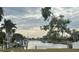 Scenic waterfront view with boat docks and tropical vegetation under a cloudy sky at 21811 Edgewater Dr, Port Charlotte, FL 33952