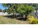 Backyard featuring trees, grass and a white fence providing a private and serene outdoor space at 2505 Minnehaha, Tampa, FL 33614